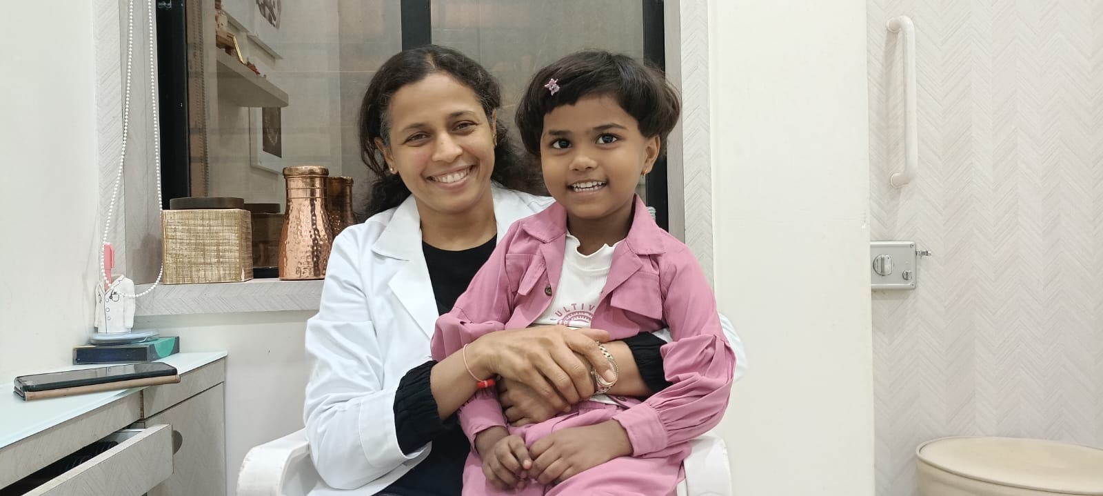 Doctor smiling with a young child patient