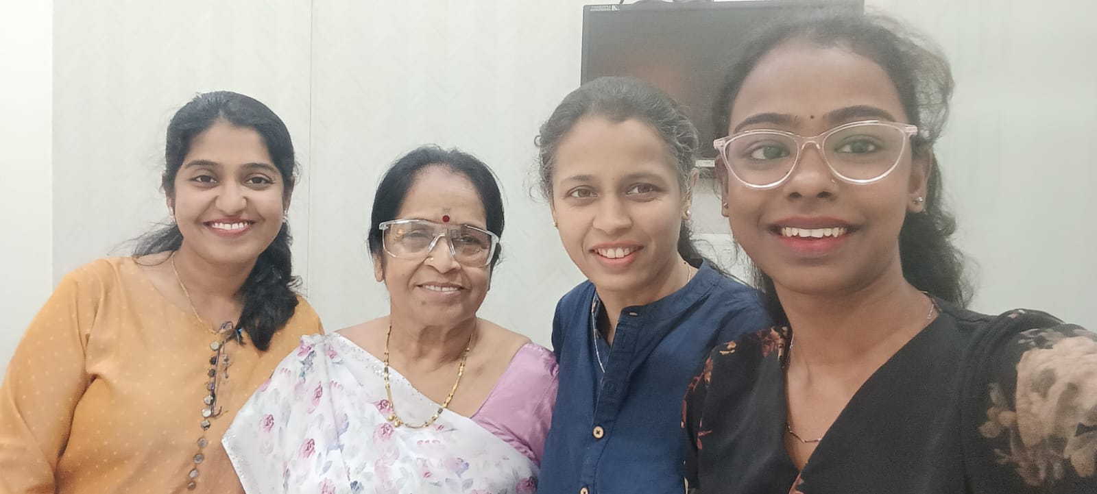 Clinic team and patient smiling after eye care