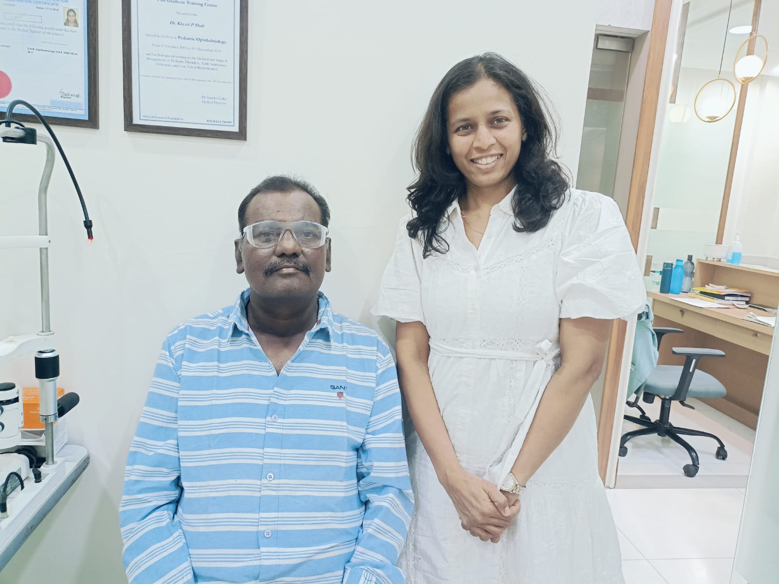 Doctor standing with a patient wearing protective glasses
