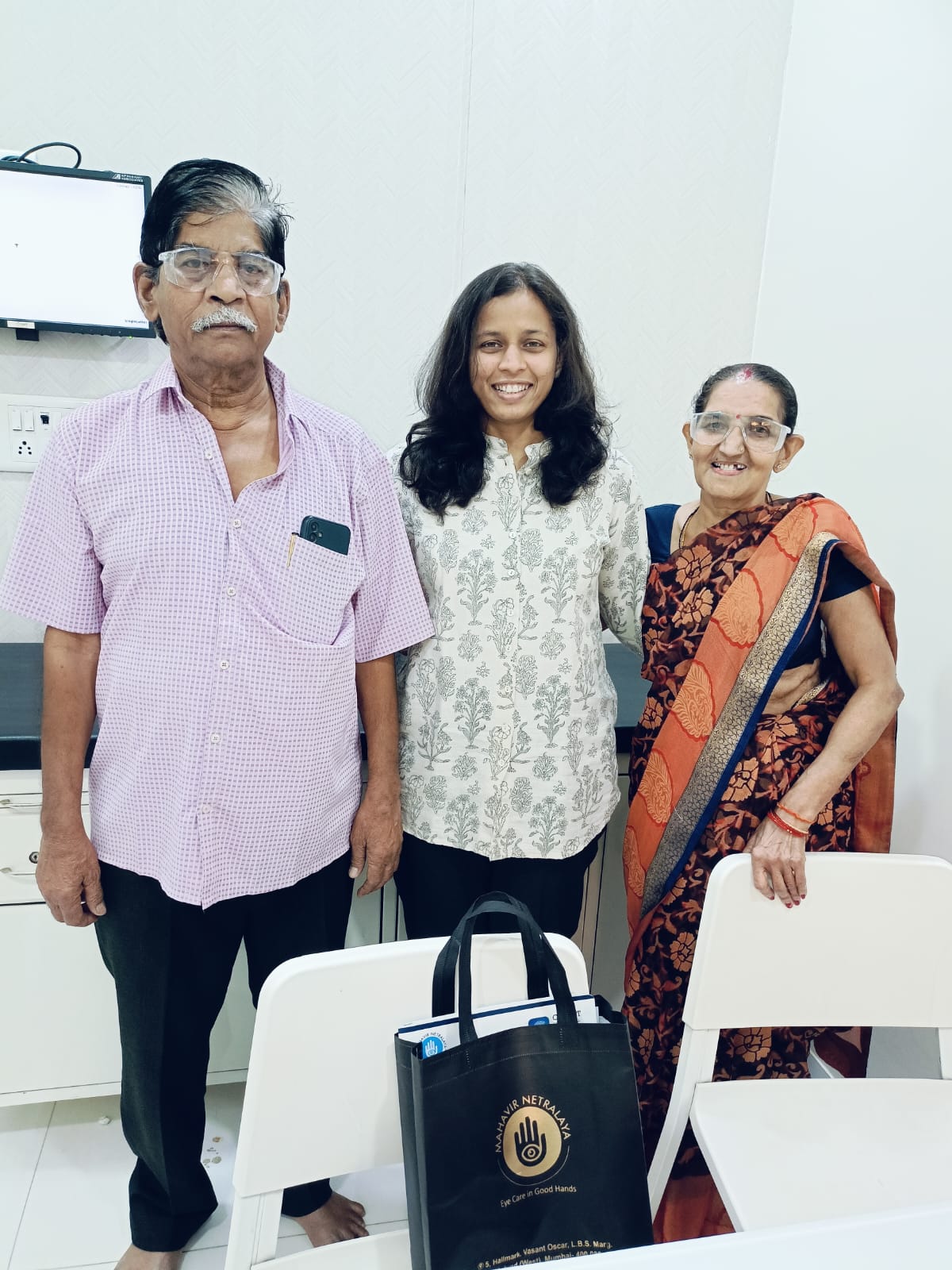 Doctor standing with two patients after treatment
